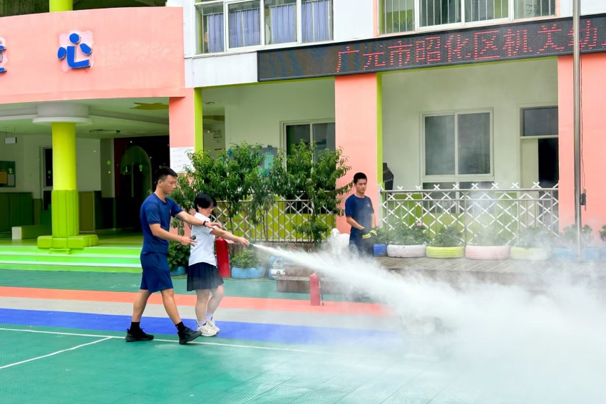 學生在消防員的引導下使用滅火器。廣元市消防救援支隊供圖