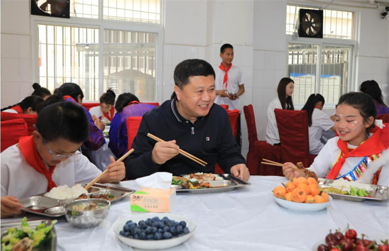 四川省副省長、阿壩州委書記徐芝文（中）在福利院與兒童共進(jìn)午餐。阿壩州民政局供圖